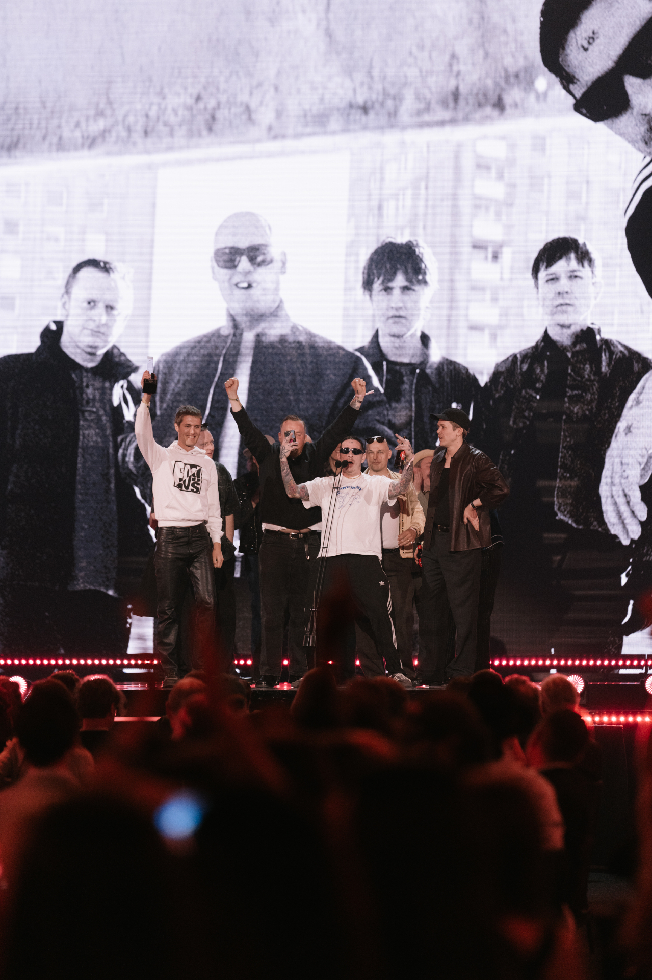 Viagra Boys at Annexet accepting a Grammis, a black and white band portrait on the screen behind them.