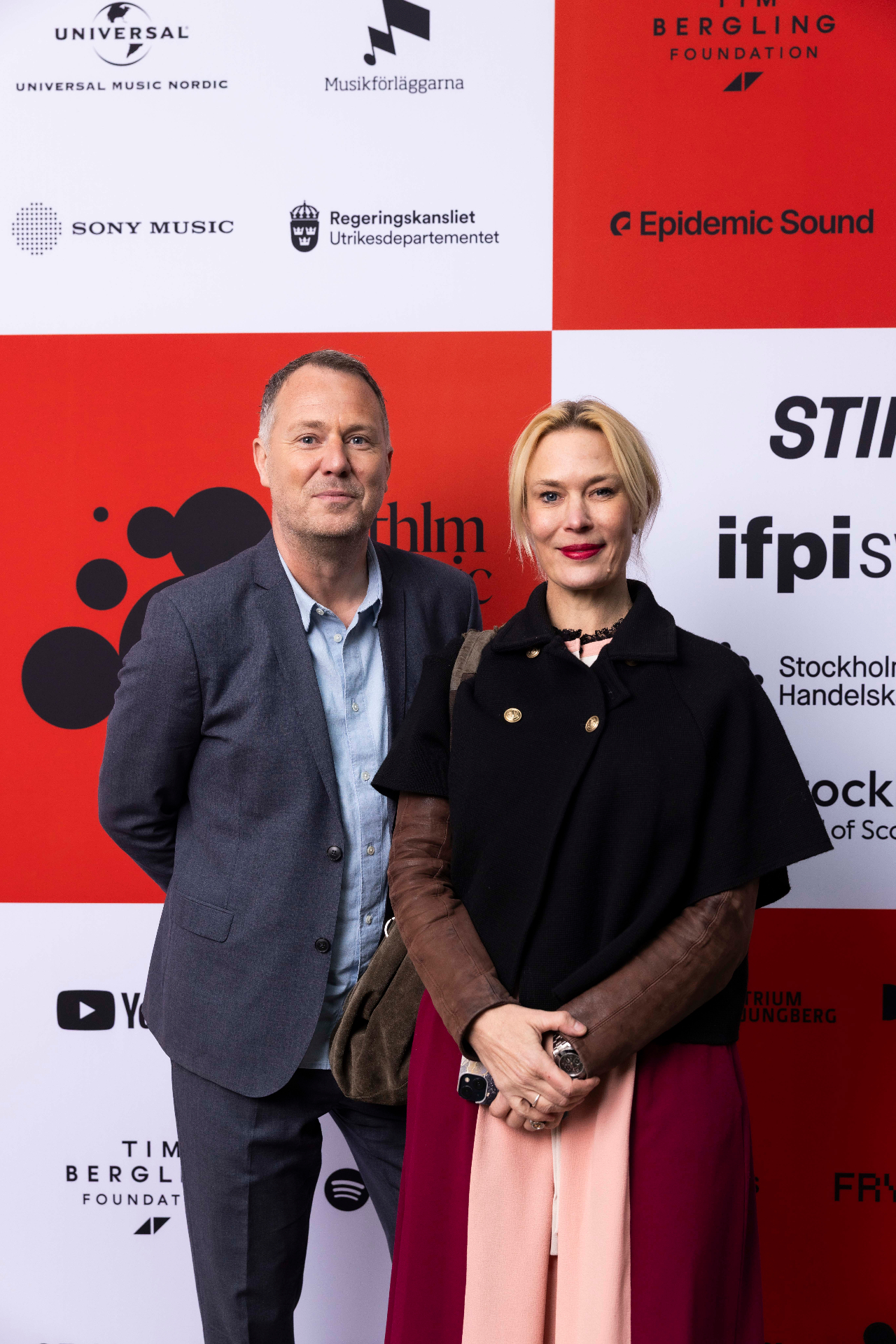 Johan Seidefors and Emilia Molin in front of the photo wall