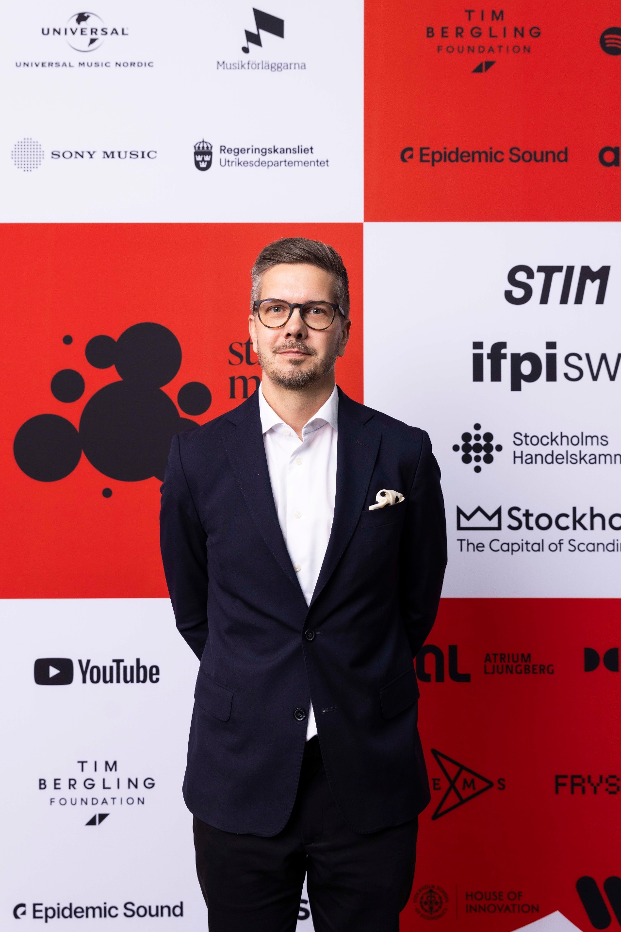 Joakim Johansson in front of the photo wall