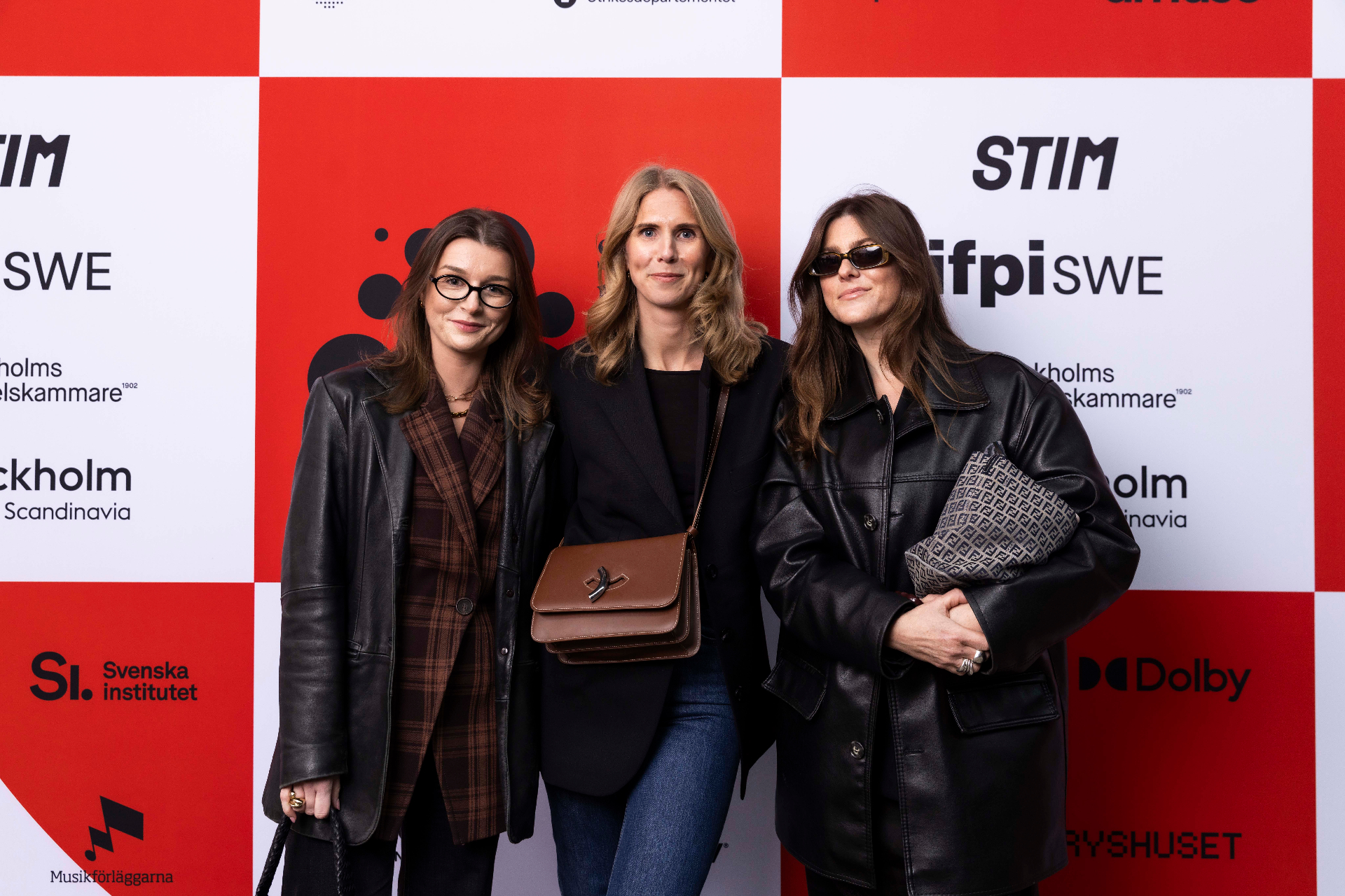 Alessia Rosi, Anna Sandell and Anna Sööder in front of the photo wall